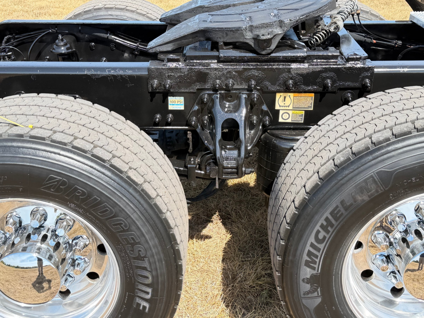 Peterbilt 579 chassis with dual rear wheels showing suspension and frame; close-up of rear axle area and tires