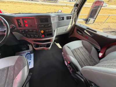 Peterbilt 579 truck interior dashboard view with steering wheel, controls, and seats visible.