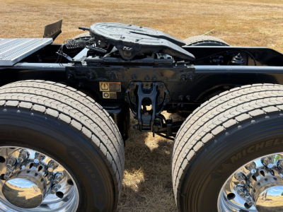Peterbilt 579 tractor rear chassis showing fifth wheel and dual rear axle tires with rims.