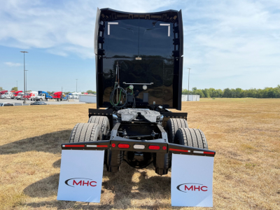 Peterbilt 579 tractor rear view showing fifth wheel mount and dual rear axles with mud flaps branded MHC.