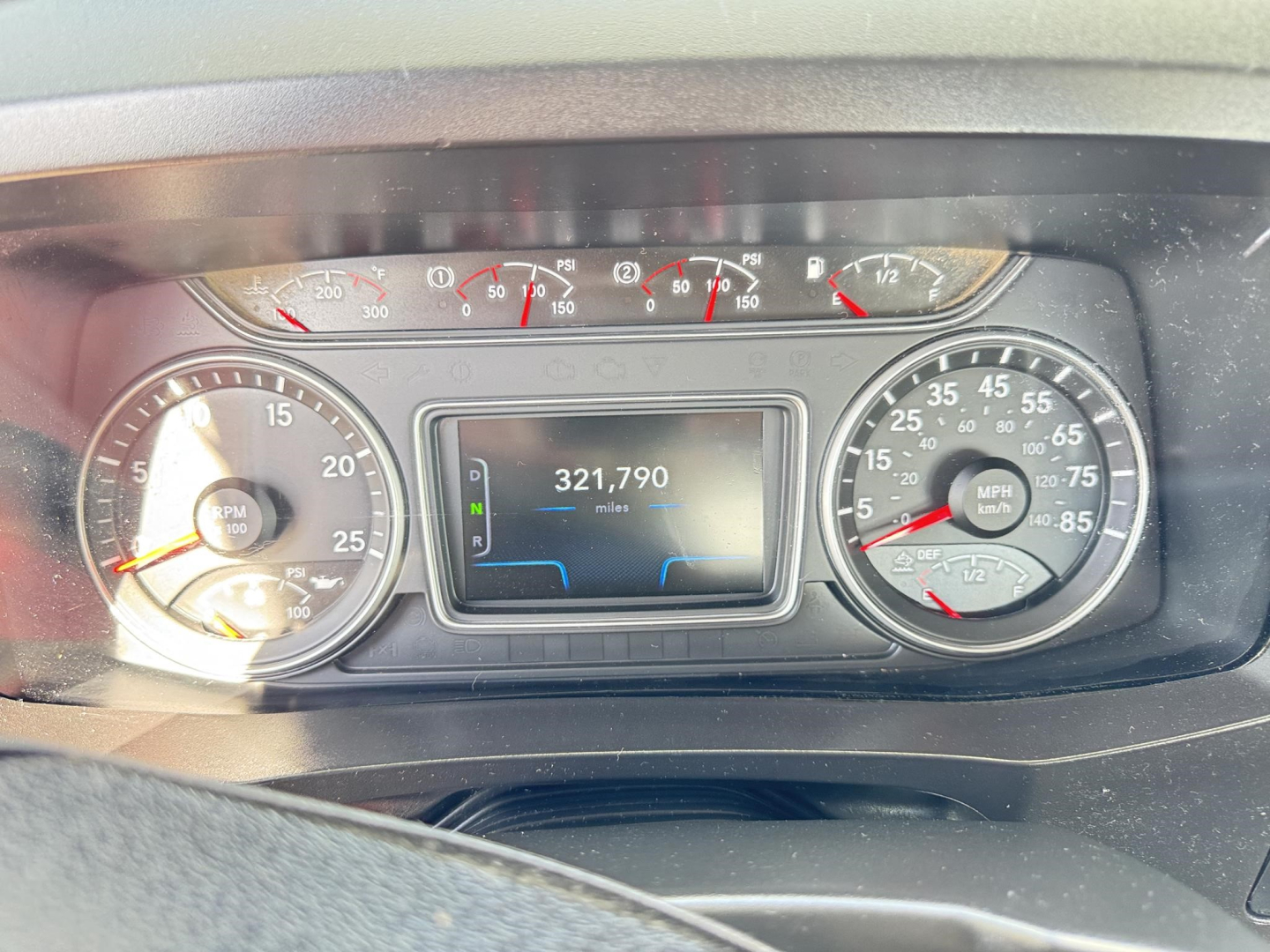 Dashboard of a 2018 International LT showing odometer reading 321,790 miles and analog gauges with speedometer and tachometer.