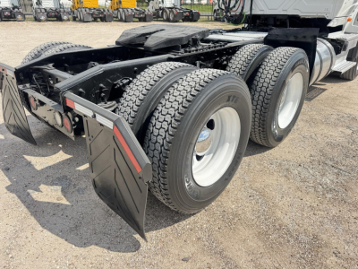 Trailer axleview showing dual rear axles and tires with mudflaps on a used 2018 International LT truck chassis.