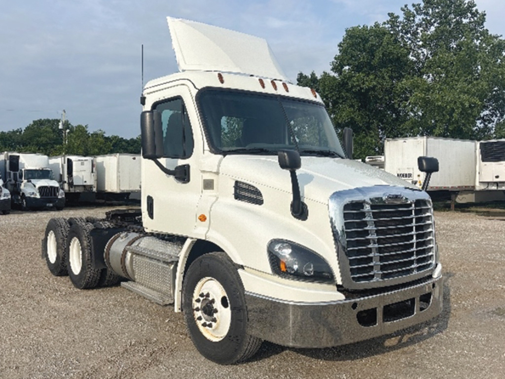White Freightliner Cascadia113 daycab tractor with raised sleeper, side mirrors, and large chrome grille. 
No legible text visible on side panels or decals in image.