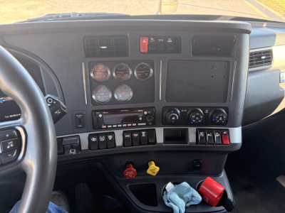 Kenworth T680 interior dashboard view showing gauges, controls, and ignition area.