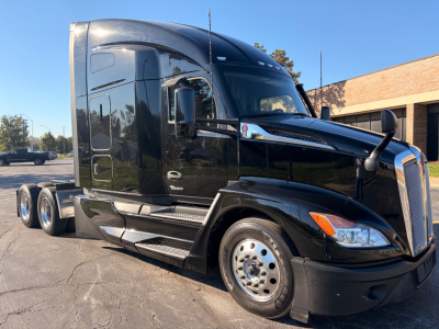 Kenworth T680 tractor unit in black, side view showing cab, chrome accents, dual rear axles, text on side reads T680.