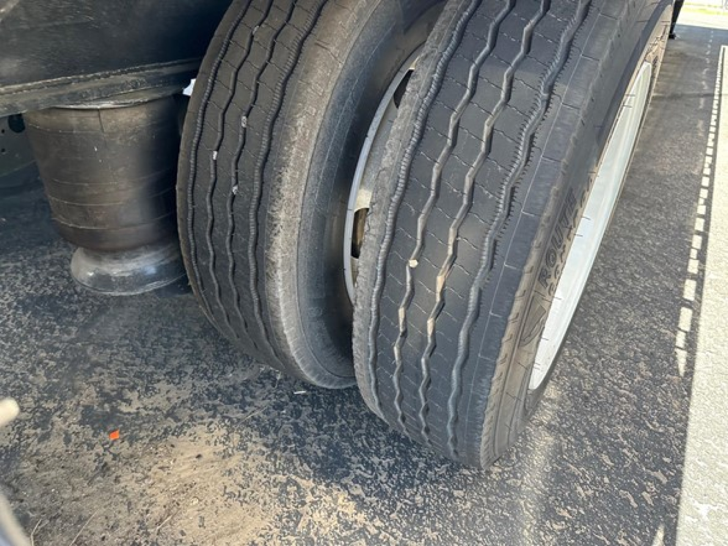 Dual rear tires on a Utility 4000Ae Combo Drop Deck trailer showing tread and wheel rims.