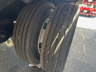 Dual rear tires of a 2023 Utility 4000AE combo drop deck trailer showing tread and wheel rims.