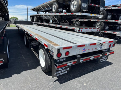 Trailer back end showing a Utility 4000Ae combo drop deck flatbed with dual rear axles and reflective tape. License plate area and Interstates branding visible.