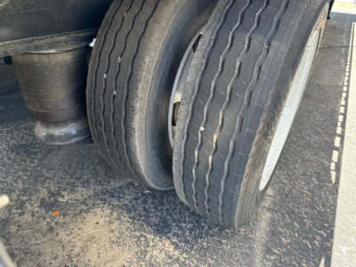 Trailer wheel and dual tires on a Utility 4000Ae Combo Drop Deck, with visible tire treads and rims, part of a drop deck trailer.