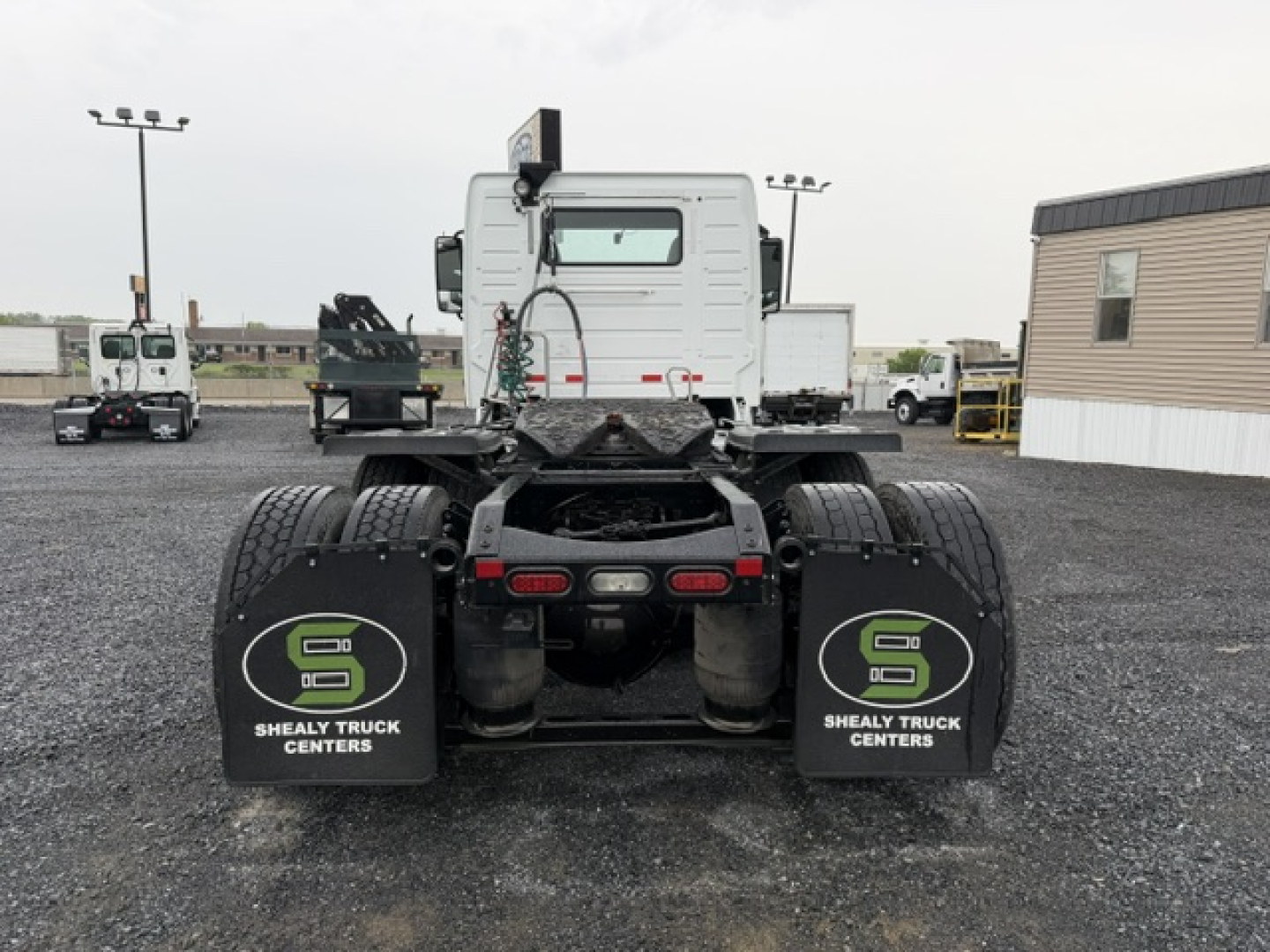 Rear view of a 2016 Volvo VNL64T300 tractor showing dual rear axles with mudflaps reading 'S' logo and 'SHEALY TRUCK CENTERS'