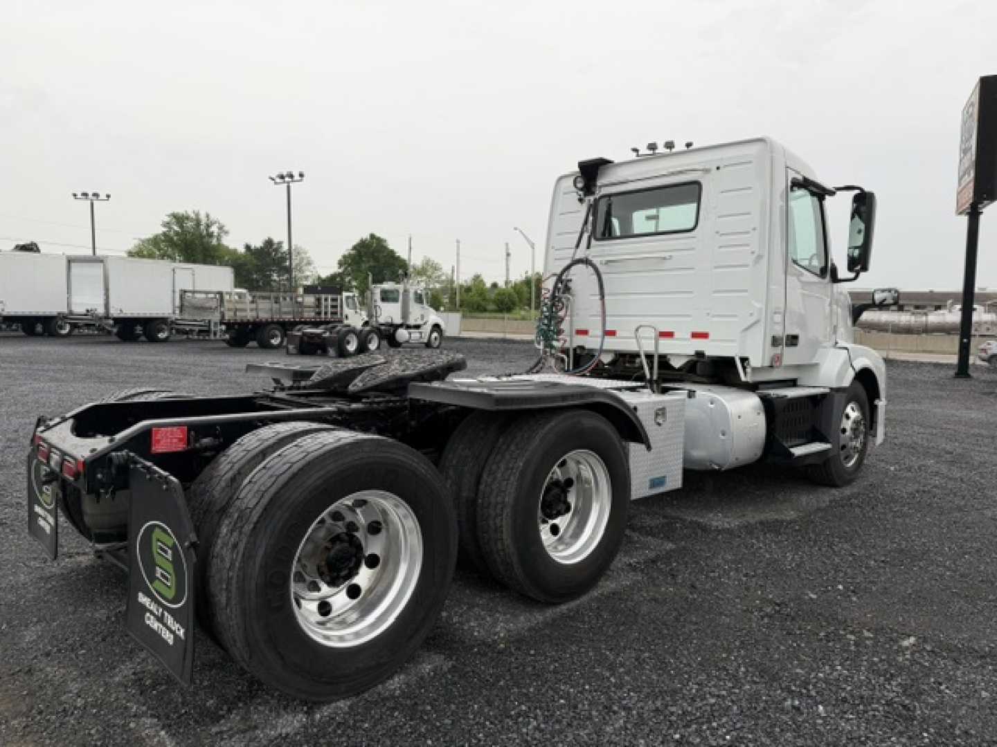 Volvo VNL64T300 tractor in-service view showing dual rear axles and wheel configuration; cab with white color and black chassis, no visible markings readable.