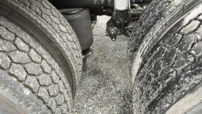 Volvo VNL64T300 truck chassis view between dual rear axles showing tires and frame.