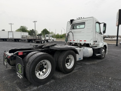 Volvo VNL64T300 tractor in-service view showing dual rear axles and wheel configuration; cab with white color and black chassis, no visible markings readable.
