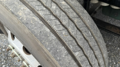Wheel and tire close-up on a Volvo VNL64T300 truck showing tread and sidewall details.