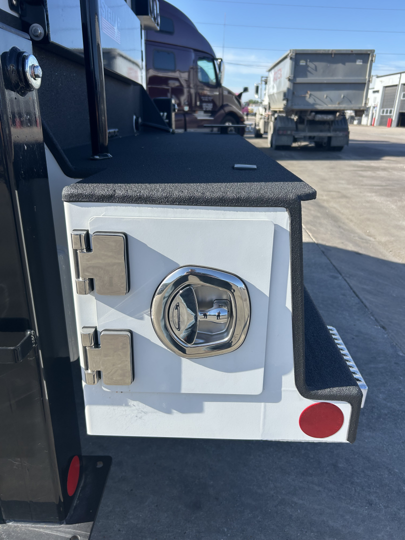 Front of a white service body door with chrome circular lock and two hinges; black textured step surface above; red round reflectors on the edge.