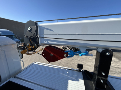 Truck side view showing hydraulic control arms and linkage on a dump bed of a 2025 Mack MD7 service truck with detailed mechanical connectors.