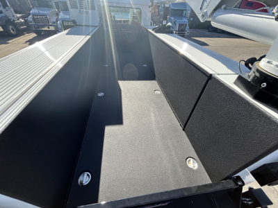 Mack MD7 service truck bed showing flatbed surface with bolts and side panels.