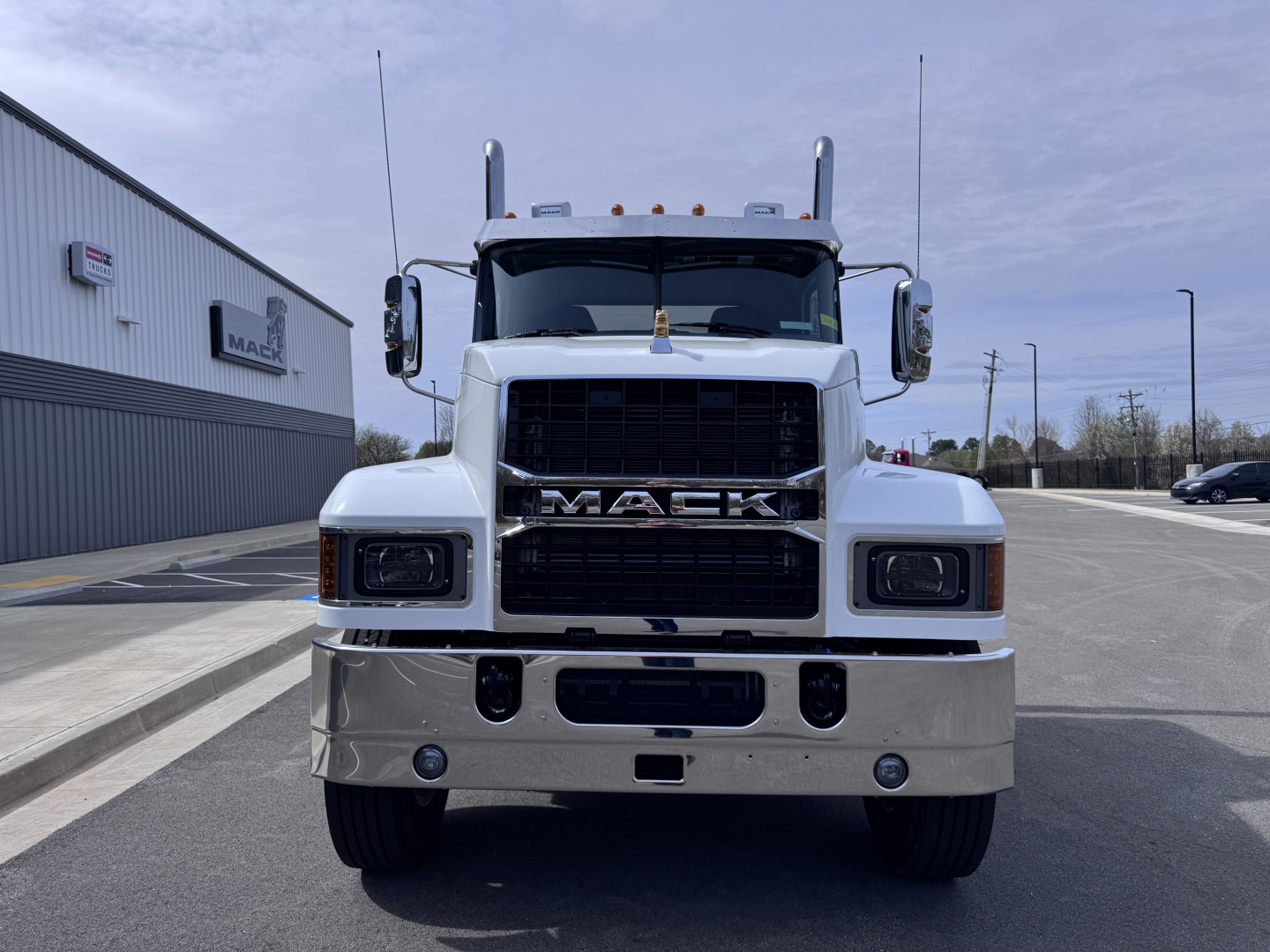 Mack PI64T conventional daycab front view showing large grille and bumper with Mack emblem.