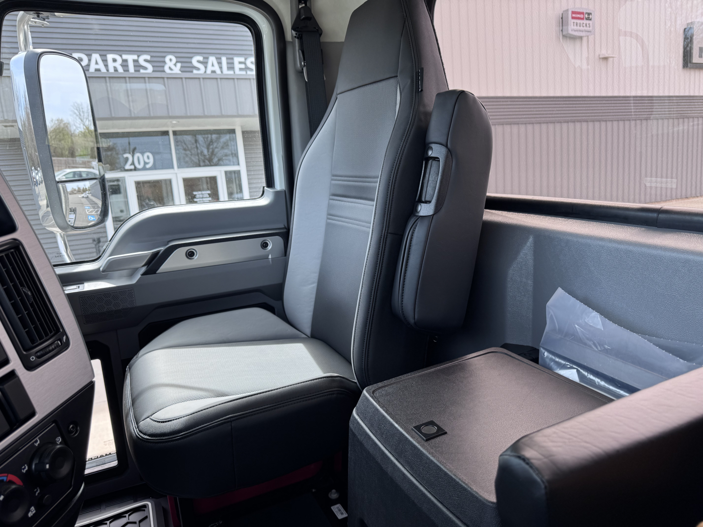 Cab interior of a 2027 Mack PI64T truck showing front passenger seat and dashboard area.
