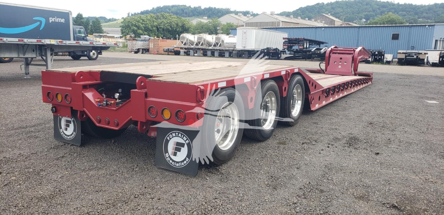Fontaine 55 PVR Pro lowboy trailer showing triple axle configuration and red painted frame.