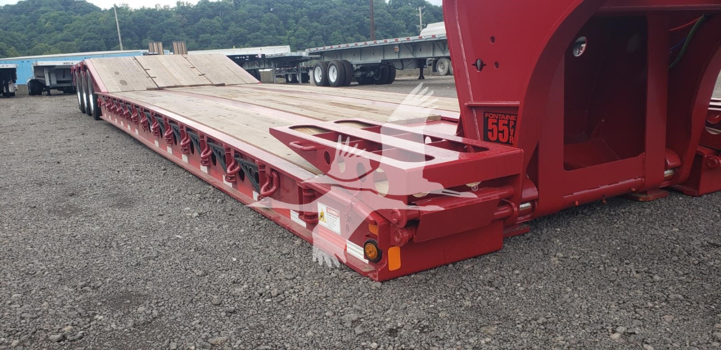 Fontaine 55 PVR Pro lowboy trailer showing rear end and red frame with deck and wheel hubs.