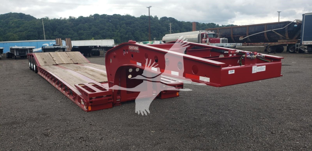 Red Fontaine 55 PVR Pro lowboy trailer chassis with flatbed deck and gooseneck, viewed from side in a yard.