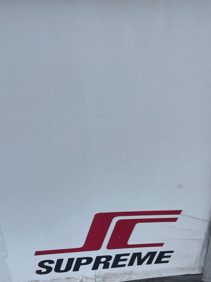 SCV Supreme logo visible on a light surface; no vehicle information readable in this image.