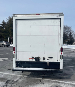 Ford Econoline commercial box truck rear view showing rear doors, tail lights, and bumper.
