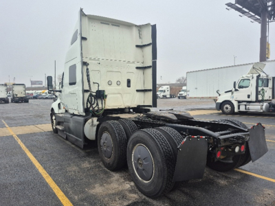 Truck cab and chassis of a used 2023 International LT625 tractor viewed from rear-left, showing dual rear axles and fifth-wheel area.
