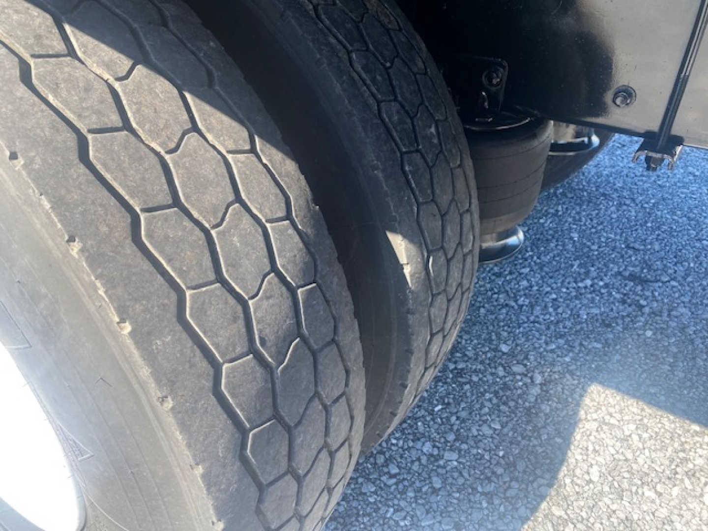Freightliner M2 106 wheel and dual rear tires in a close-up view with suspension components visible