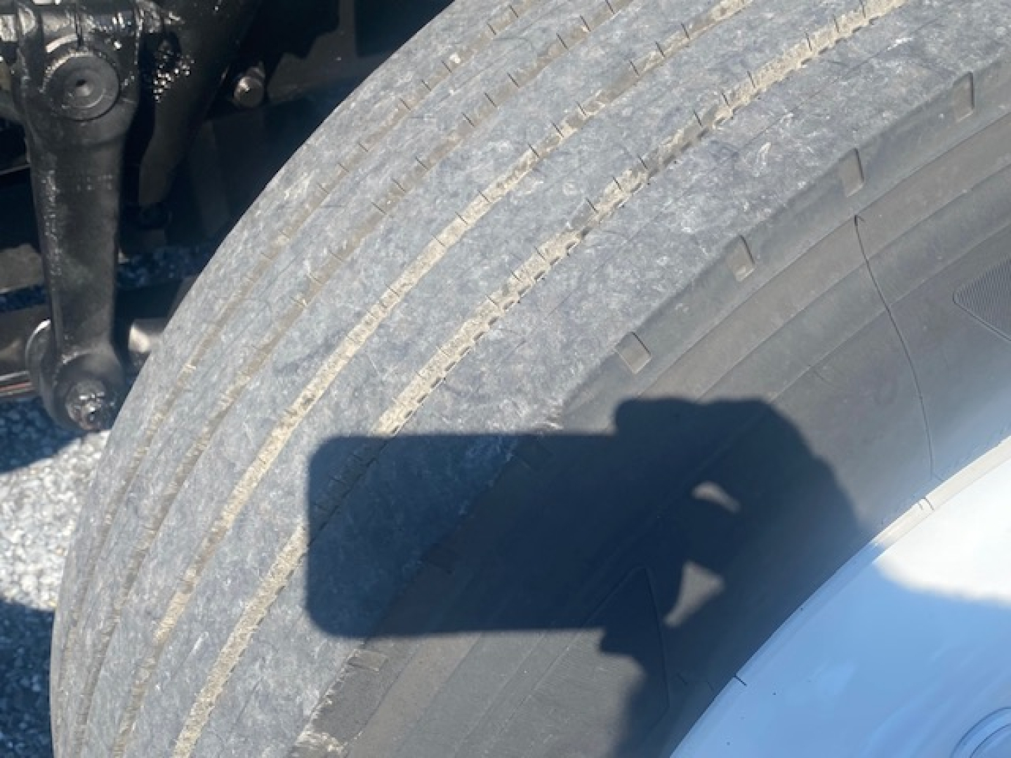 Freightliner M2 106 wheel and tire undercarriage view showing exposed suspension components and tire tread
