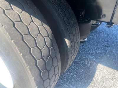 Freightliner M2 106 wheel and dual rear tires in a close-up view with suspension components visible