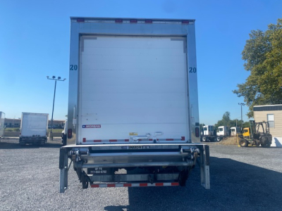 Freightliner M2 106 refrigerated truck rear view showing lift gate and bumper with reflective tape.
