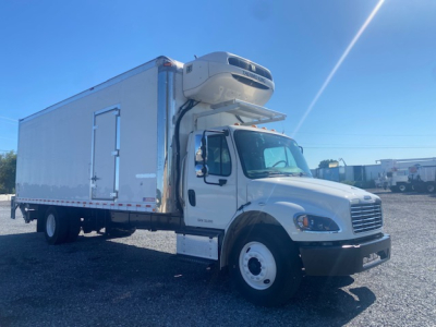 Freightliner M2 106 box truck with a refrigeration unit mounted on cab; white exterior; side view showing cooler