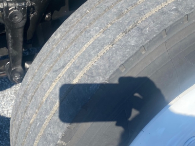 Freightliner M2 106 wheel and tire undercarriage view showing exposed suspension components and tire tread