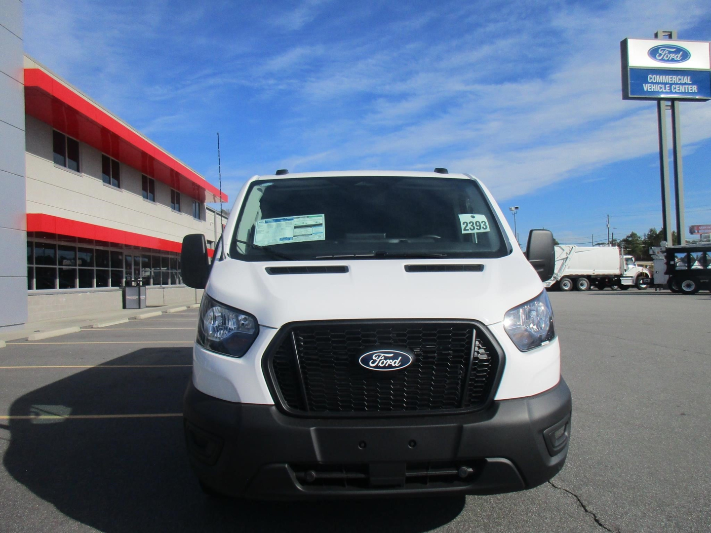 Ford Transit cargo van front view showing black grille and Ford emblem.