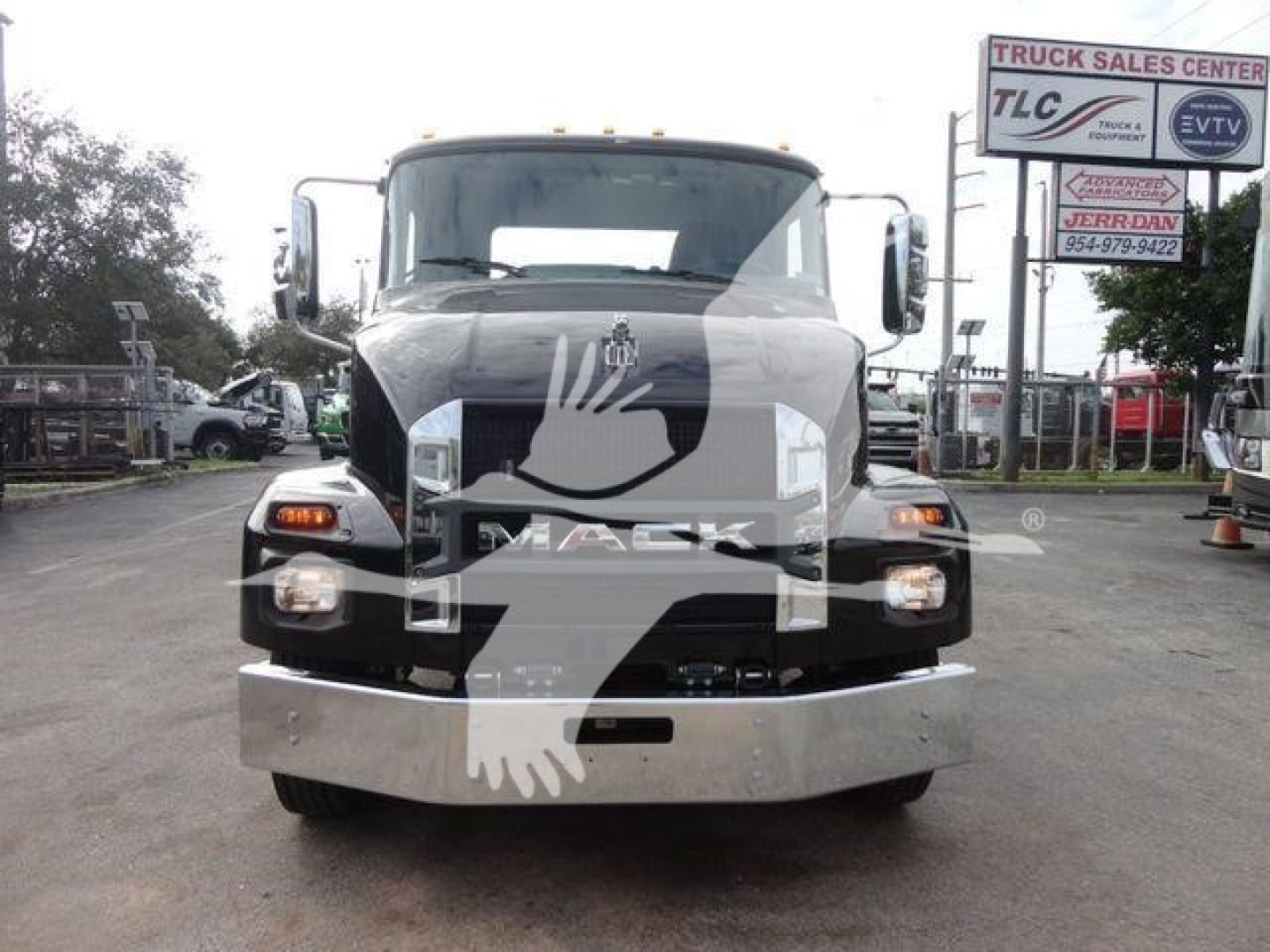 Front view of a new 2027 Mack MD6 rollback trucks showing large chrome bumper and headlights.