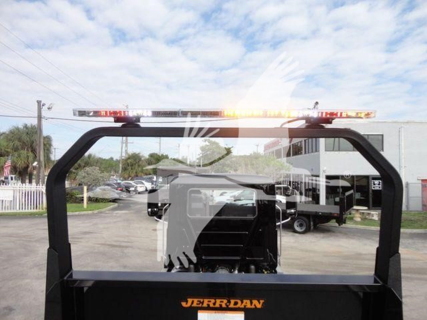 Mack MD6 rollback truck cab view with lightbar showing Jerr-Dan branding and rear setup.