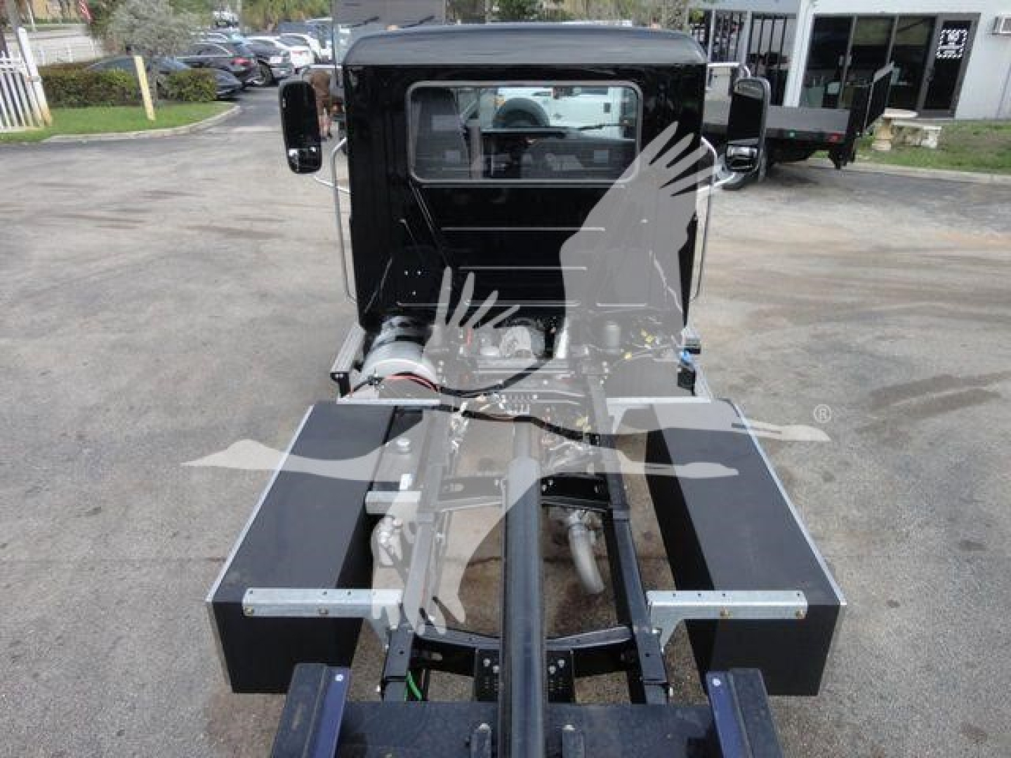 Mack MD6 truck cab and chassis showing front view with fuel tanks and hitch area.