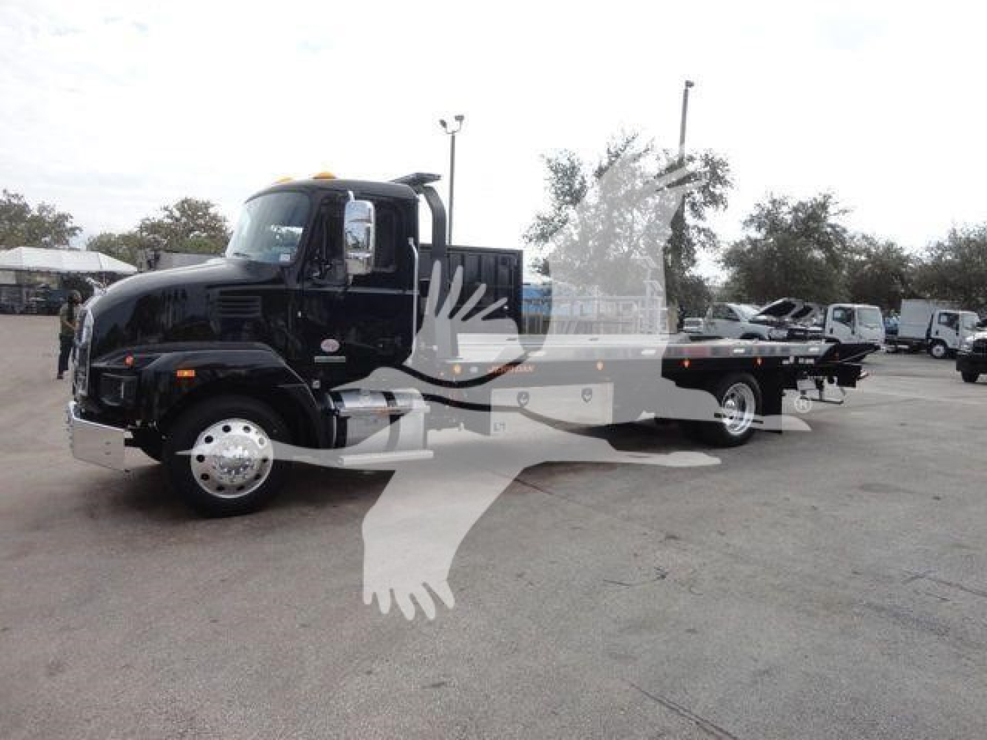 Truck cab and flatbed rollback w/ reflection on watermarked image