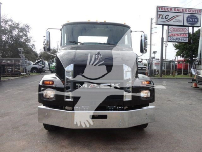 Front view of a new 2027 Mack MD6 rollback trucks showing large chrome bumper and headlights.