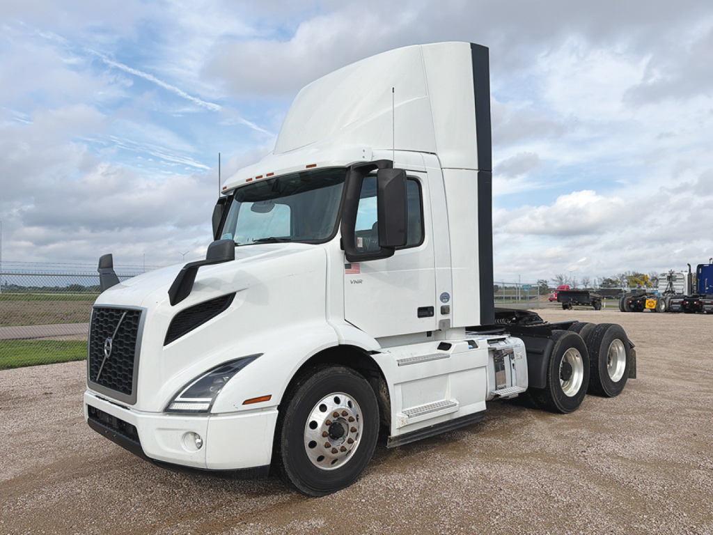 Volvo VNR 300 tractor-trailer cab in white, front and side view showing aerodynamic grille and sleeper cab