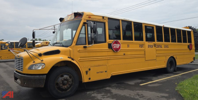 Yellow Freightliner Thomas Saf-T-Liner C2 school bus with stop sign and large front grille; visible text includes STOP sign, '51' door, 'PORT', 'B21', and other route markings along side.