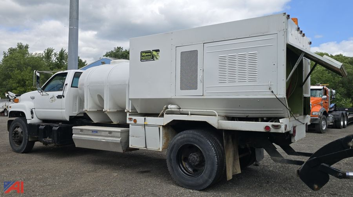 GMC TopKick C7500 utility truck with a large cylindrical tank and rear utility box, side view showing tanker and service compartments.
