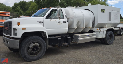 GMC TopKick C7500 tank utility truck with large stainless steel tank and utility box on the bed, front left view