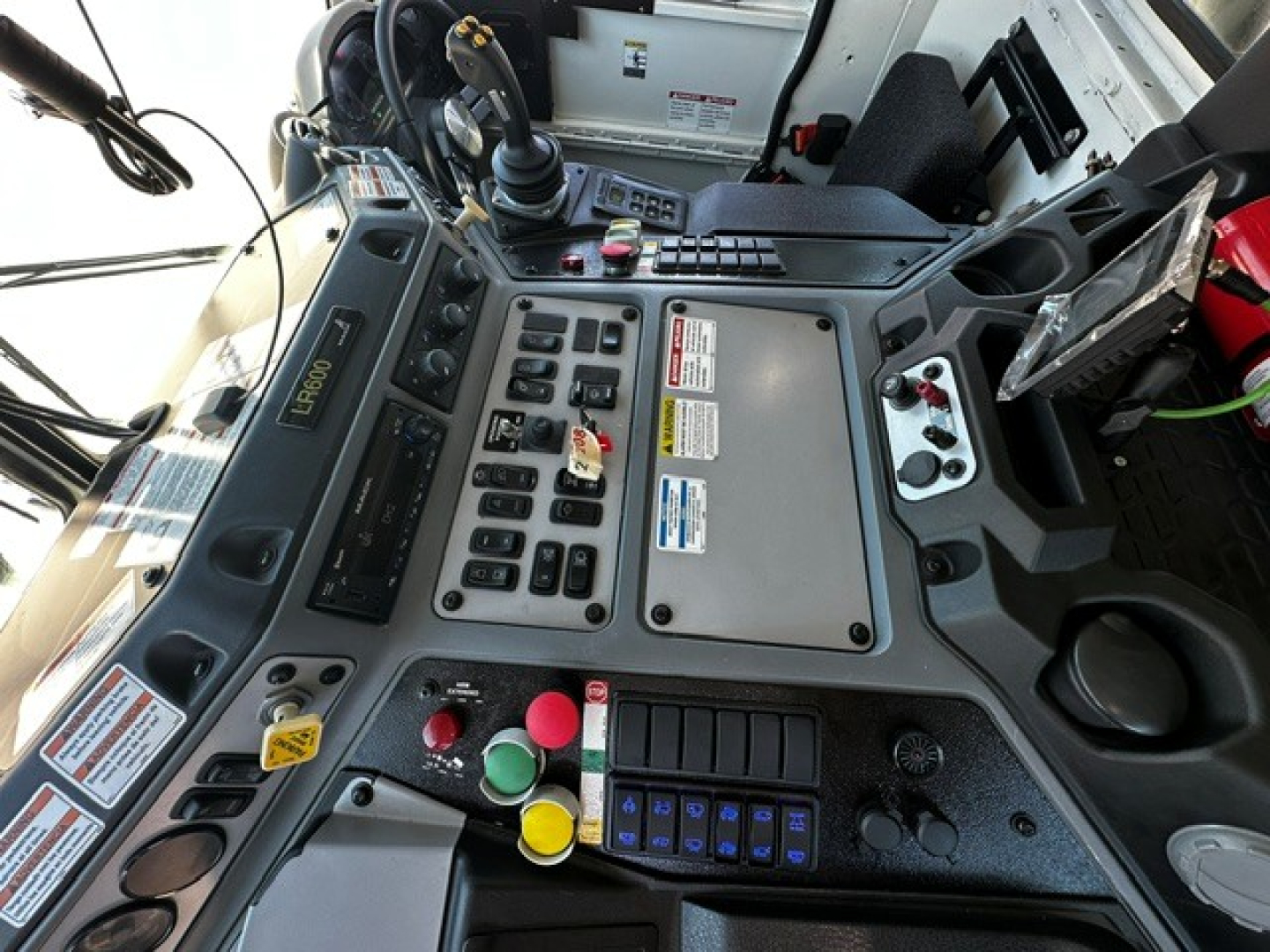 Mack LR64 truck cab interior dashboard showing control panels, buttons, and display screens.