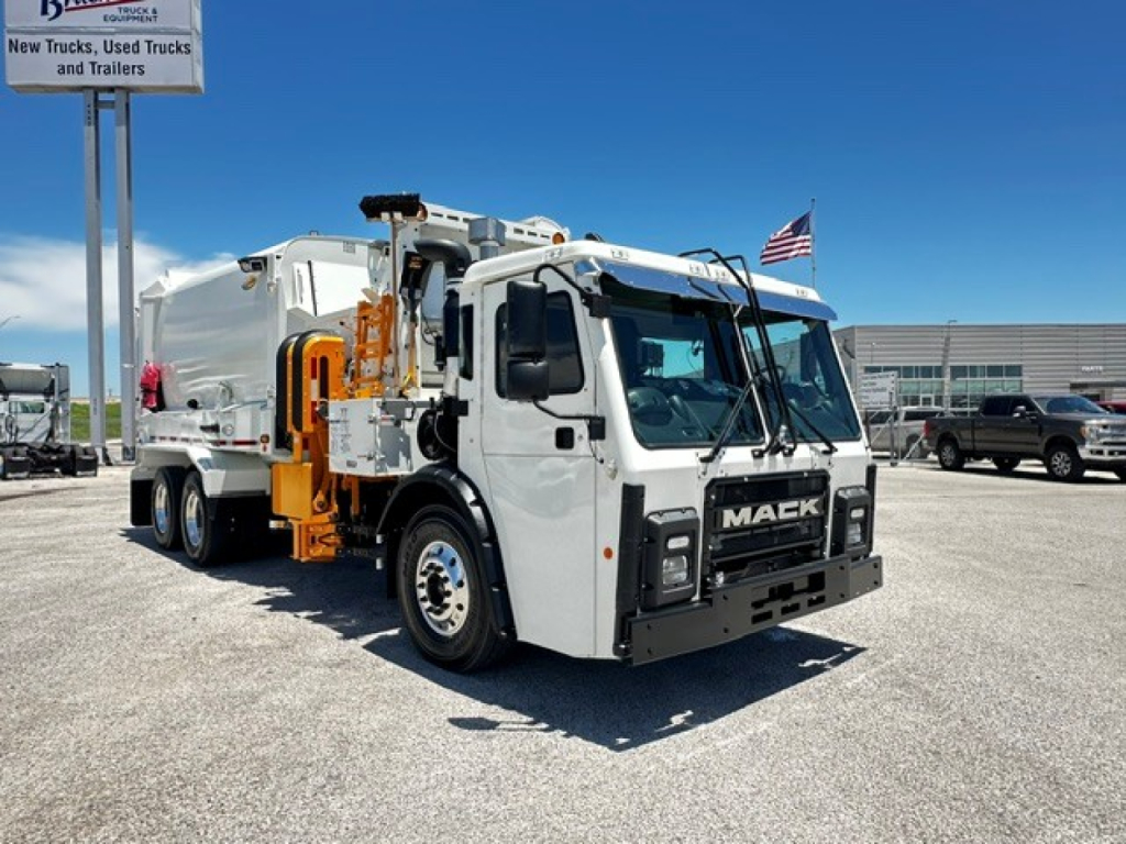 Mack LR64 street-cleaning/garbage truck in white with orange rear compactor, front view showing MAek grille and side mirrors.