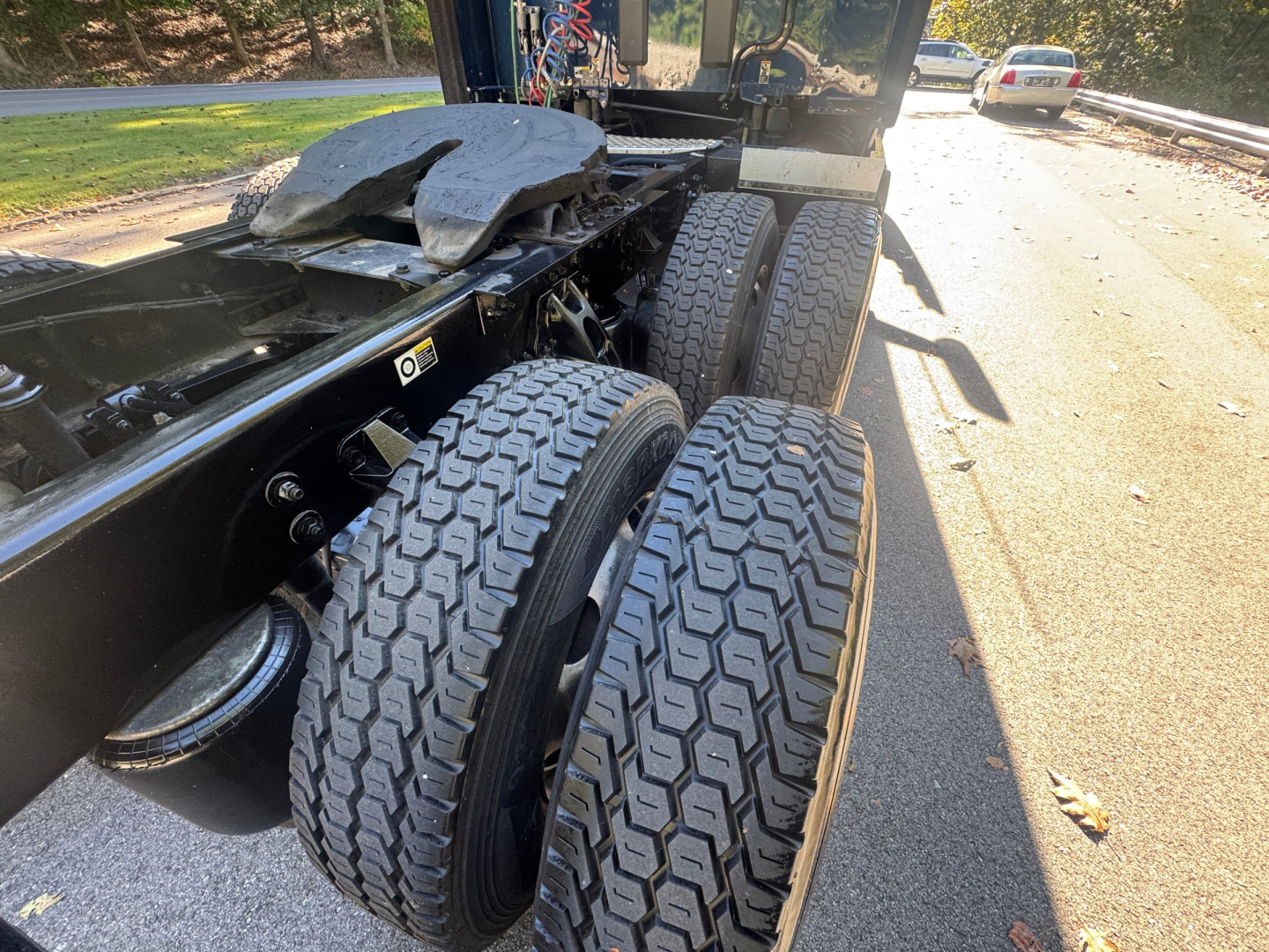 Kenworth T680 chassis and dual rear axles showing tandem wheels and suspension components.