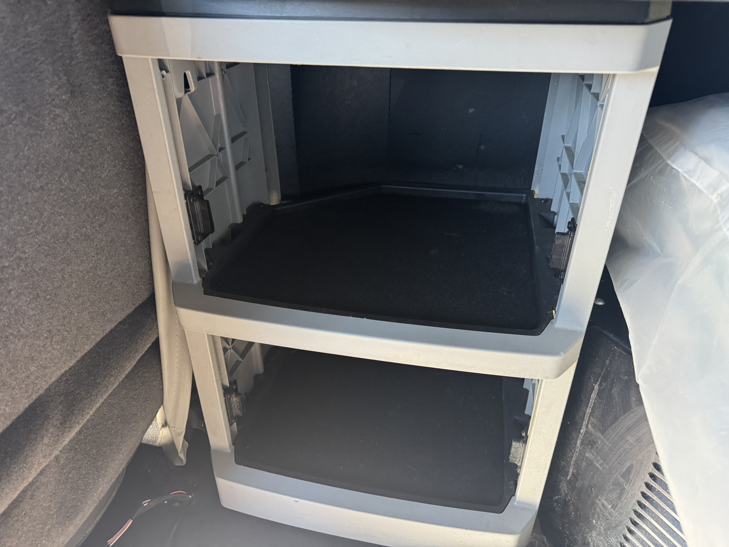 Cabinet-style storage drawers in Kenworth T680 cab interior showing empty open compartments.