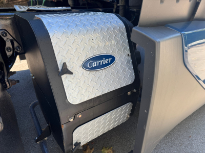 Carrier auxiliary power unit cover and Diamond Plate access panel on a 2024 Kenworth T680 engine area
